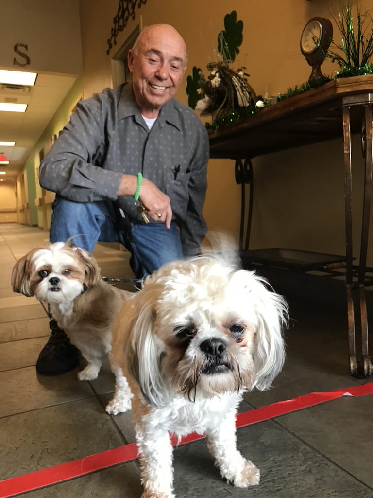 Emotional Support dogs for residence. Man walking two small dogs at Ravenna Assisted Living.